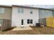 View of the backyard with a concrete patio and partial fencing on a cloudy day at 7540 Knoll Hollow Rd, Lithonia, GA 30058