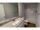 Bathroom featuring granite vanity, framed mirror, and a shower-tub combination at 7540 Knoll Hollow Rd, Lithonia, GA 30058