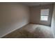 Bedroom featuring carpet, a window with blinds, and light-colored walls at 7540 Knoll Hollow Rd, Lithonia, GA 30058