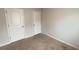 A neutral bedroom featuring two white doors and a light switch at 7540 Knoll Hollow Rd, Lithonia, GA 30058