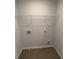 An unfinished laundry room featuring wire shelving and washing machine hookups at 7540 Knoll Hollow Rd, Lithonia, GA 30058