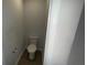 Small toilet room with wood floors, a white toilet and white walls at 7540 Knoll Hollow Rd, Lithonia, GA 30058