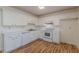 The kitchen features pristine white cabinetry, modern appliances, and sleek hardwood floors at 2813 Melanie Ln, Douglasville, GA 30135