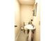 Cozy half-bath featuring a pedestal sink, blue tile floors, and a decorative gold trimmed mirror at 3720 Riviera Dr, Cumming, GA 30041