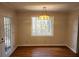 Dining room with wood floors, a pendant light, and a view of the backyard at 3720 Riviera Dr, Cumming, GA 30041