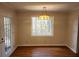 Bright dining room with hardwood floors and large window at 3720 Riviera Dr, Cumming, GA 30041