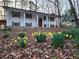 Charming two-story home featuring a covered front porch and daffodil landscaping at 3720 Riviera Dr, Cumming, GA 30041