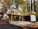 Rear view of home with attached two car garage and outdoor deck at 3720 Riviera Dr, Cumming, GA 30041