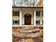 This home boasts a covered front entry with stone steps and a unique front door at 3720 Riviera Dr, Cumming, GA 30041