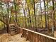 View from wood deck with stairs and wood railing overlooking a wooded lot at 3720 Riviera Dr, Cumming, GA 30041