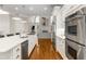 Modern kitchen with white cabinets, stainless steel appliances, and hardwood floors at 916 Saint Lyonn Cts, Marietta, GA 30068