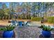 Inviting pool area with fire pit, patio, and lush landscaping at 916 Saint Lyonn Cts, Marietta, GA 30068