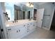 Bright bathroom with double sinks, white cabinets, and a walk-in shower behind a glass enclosure at 3711 Club Nw Dr, Kennesaw, GA 30144