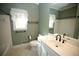 Neutral-colored bathroom features a large mirror, sink, toilet, and shower with tub at 3711 Club Nw Dr, Kennesaw, GA 30144