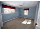 Bedroom with carpet, two windows with red curtains, and a ceiling fan with light at 3711 Club Nw Dr, Kennesaw, GA 30144