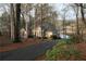 Charming brick home with beautiful landscaping and a private driveway near a serene lake at 3711 Club Nw Dr, Kennesaw, GA 30144