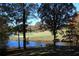 Picturesque view of a golf course and a pond surrounded by lush greenery at 3711 Club Nw Dr, Kennesaw, GA 30144