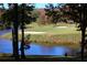 Scenic view of a golf course and a pond framed by mature trees at 3711 Club Nw Dr, Kennesaw, GA 30144
