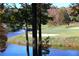 Scenic golf course with pond, sand trap, and lush trees at 3711 Club Nw Dr, Kennesaw, GA 30144