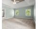 Spacious main bedroom featuring tray ceilings, neutral carpet, and natural light from dual windows at 3711 Club Nw Dr, Kennesaw, GA 30144