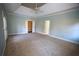 Spacious main bedroom features tray ceiling, ceiling fan, carpet flooring, and double door entry at 3711 Club Nw Dr, Kennesaw, GA 30144