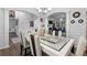 Bright dining room with a modern table and access to other rooms at 7417 Jennadee Dr, Fairburn, GA 30213