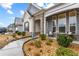 Inviting front porch with stone and gray siding exterior at 7417 Jennadee Dr, Fairburn, GA 30213