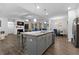 Open concept kitchen with kitchen island, stainless appliances and view of the living room at 7417 Jennadee Dr, Fairburn, GA 30213