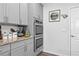 Well-organized kitchen features gray cabinets, granite countertops, and stainless steel double ovens at 7417 Jennadee Dr, Fairburn, GA 30213