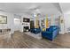 Comfortable living room featuring a fireplace, large windows, and stylish blue sofas at 7417 Jennadee Dr, Fairburn, GA 30213
