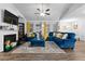 Bright and airy living room boasts vaulted ceilings, a fireplace, and stylish blue furniture at 7417 Jennadee Dr, Fairburn, GA 30213