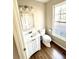 Bathroom featuring a new vanity, mirror, and toilet with a window for natural light at 2610 Woodridge Chase, Canton, GA 30114