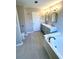 Bright bathroom featuring double vanity, soaking tub, tiled floors and a separate glass shower at 2610 Woodridge Chase, Canton, GA 30114