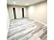Bright bedroom featuring light gray vinyl plank flooring and large closet space at 2610 Woodridge Chase, Canton, GA 30114