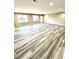 Expansive living room with gray wood flooring, recessed lighting, and natural light from large windows at 2610 Woodridge Chase, Canton, GA 30114