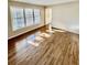 Sunlit living room featuring gleaming hardwood floors and large windows at 2610 Woodridge Chase, Canton, GA 30114