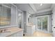 Elegant bathroom with double vanity, beige tile floors, and a large mirror at 2960 S Pharr Nw Ct # N2, Atlanta, GA 30305