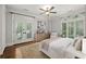 Serene bedroom with hardwood floors, french doors, and a cozy sitting area at 2960 S Pharr Nw Ct # N2, Atlanta, GA 30305