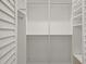 Bright walk-in closet with built-in shelves and hanging rods at 2960 S Pharr Nw Ct # N2, Atlanta, GA 30305