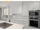 Modern kitchen with white cabinets and marble countertops at 2960 S Pharr Nw Ct # N2, Atlanta, GA 30305