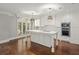 Eat-in kitchen with white cabinets, marble island, and hardwood floors at 2960 S Pharr Nw Ct # N2, Atlanta, GA 30305