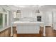 Bright, open kitchen features white cabinets, marble countertops, and stainless steel appliances at 2960 S Pharr Nw Ct # N2, Atlanta, GA 30305
