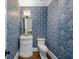 Stylish powder room with designer wallpaper and marble vanity at 2960 S Pharr Nw Ct # N2, Atlanta, GA 30305
