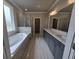 Spa-like primary bathroom with a soaking tub, double vanities, and a glass shower at 3019 Fairway Dr, Villa Rica, GA 30180