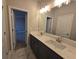 Modern bathroom featuring double sinks, granite countertop, and neutral color palette at 3019 Fairway Dr, Villa Rica, GA 30180