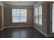 Bright dining area with large windows, dark wood floors, and modern light fixture at 3019 Fairway Dr, Villa Rica, GA 30180