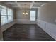 Bright dining room with dark wood floors, a coffered ceiling, and white wainscoting at 3019 Fairway Dr, Villa Rica, GA 30180