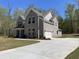Gray brick home features a well-manicured lawn and extended driveway at 3019 Fairway Dr, Villa Rica, GA 30180