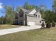 Newly constructed gray brick home with well-manicured front lawn and covered porch at 3019 Fairway Dr, Villa Rica, GA 30180