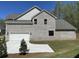 Home featuring a two-car garage and driveway, framed by lush landscaping at 3019 Fairway Dr, Villa Rica, GA 30180